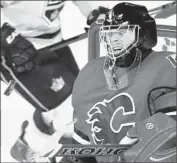  ?? Larry MacDougal Associated Press ?? THE PUCK is coming in fast on Flames goalie Jonas Hiller, who makes the first-period save.