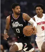  ?? RAUL ROMERO JR. — THE ASSOCIATED PRESS ?? The Clippers' Paul George dribbles the ball up the court as the Pistons' Ausar Thompson gives chase.