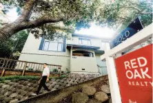  ?? Noah Berger / Special to The Chronicle ?? Real estate agent Justin Palmer leaves an Oakland home he recently helped San Francisco buyers purchase.