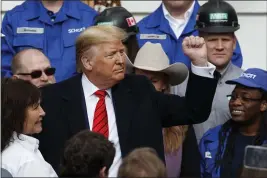  ?? ALEX BRANDON — THE ASSOCIATED PRESS ?? President Donald Trump pumps his fist after signing a new North American trade agreement with Canada and Mexico during an event at the White House in Washington on Wednesday.