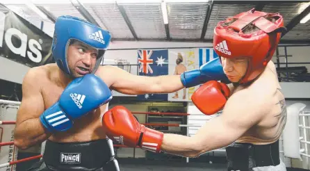  ?? Picture: GLENN HAMPSON ?? Dean Morrison (blue) sparring with former boxing star Michael Katsidis in preparatio­n for King of the Coast.