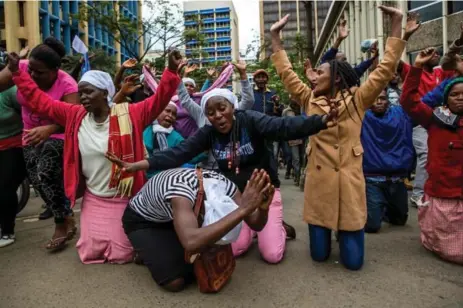  ?? PATRICK MEINHARDT/AFP/GETTY IMAGES ?? Supporters of Kenyan President Uhuru Kenyatta celebrated the news that the vote would proceed after a last-minute petition to postpone it failed.