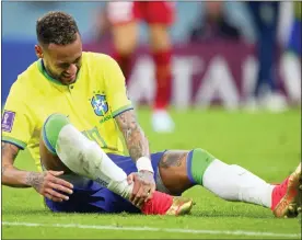  ?? LAURENT GILLIERON — KEYSTONE VIA AP ?? Brazil’s Neymar grabs his ankle after an injury during the World Cup group G soccer match between Brazil and Serbia, at the the Lusail Stadium in Lusail, Qatar on Thursday, Nov. 24, 2022.