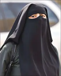  ?? Canadian Press photo ?? A woman wears a niqab as she walks in Montreal in a 2013 file photo.