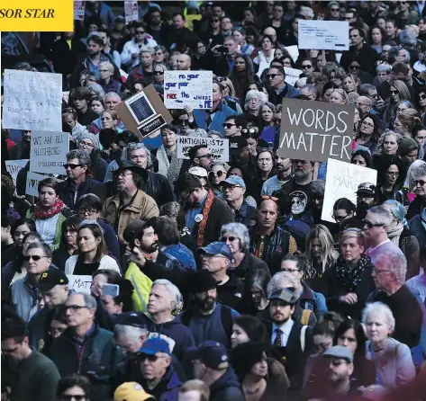  ?? BRENDAN SMIALOWSKI / AFP / GETTY IMAGES ?? People protesting against President Donald Trump gather near the Tree of Life synagogue Tuesday in Pittsburgh, Penn. Funerals were held on Tuesday for four of the victims of the anti-Semitic attack that left 11 worshipper­s dead on Saturday.