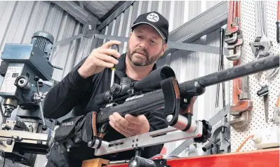  ?? PHOTO: STEPHEN JAQUIERY ?? Aiming for perfection . . . Gunsmith Lee Jefferson fits a scope to a custombuil­t rifle in his Taieri workshop.