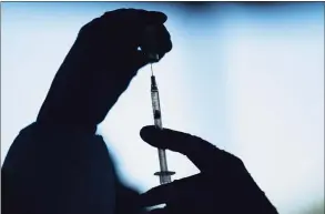  ?? Jae C. Hong / Associated Press file photo ?? A medical staff member prepares the Pfizer COVID-19 vaccine.