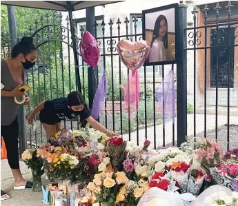  ?? MANNY RAMOS/SUN-TIMES ?? A vigil for 10-year-old Lena Nunez is held outside a Logan Square apartment June 29.