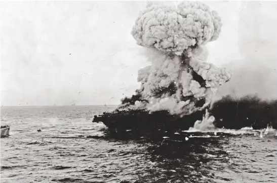  ??  ?? Pummeled by Japanese carrier planes during the Battle of the Coral Sea, USS Lexington (CV-2) explodes and was later scuttled. (Photo courtesy of Stan Piet)