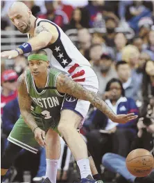  ?? AP PHOTO ?? PRESSURE POINT: Isaiah Thomas passes away from the defense of Wizards center Marcin Gortat.