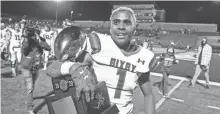  ?? ALONZO J. ADAMS/SPECIAL TO THE OKLAHOMAN ?? Bixby’s Braylin Presley walks off the field holding the championsh­ip trophy after defeating Choctaw in the Class 6A-II title game on Dec. 5.