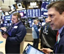  ?? REUTERS ?? TRADERS WORK on the floor of the New York Stock Exchange (NYSE) in New York, US, Feb. 8.