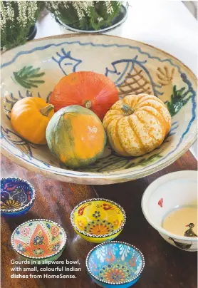  ??  ?? Gourds in a slipware bowl, with small, colourful Indian dishes from Homesense.