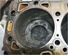  ??  ?? There it is, the tell-tale signs of a blown head gasket. On this truck, considered low mileage at just 86,000, it’s obvious the passenger No. 7 rear gasket had let go allowing coolant to enter the combustion chamber. An updated GM head gasket supplied...