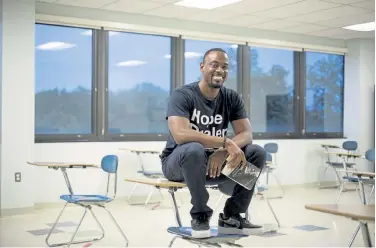  ?? Steve Legato, © The New York Times Co. ?? Lamin Ngobeh, a high school teacher at Freire Charter School who plans to move temporaril­y to Barbados in September, sits in a classroom in Wilmington, Del., on Monday. Several countries with fragile tourist economies have started to offer visas that allow foreigners to live and work for a period of at least six months.