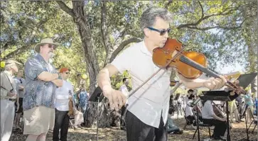  ?? Brian van der Brug
Los Angeles Times ?? CALARTS
Ensemble violist Mark Menzies performs John Luther Adams’ “Sila” on Thursday at Libbey Park.