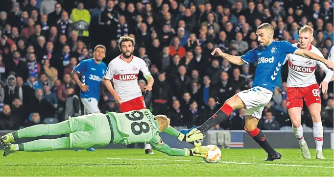  ?? Pictures: SNS. ?? Above: Spartak goalkeeper Aleksandr Maksimenko dives out to deny Eros Grezda; right: Daniel Candeias fires wildly across goal from a good position.