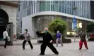  ?? Aly Song/Reuters ?? People wearing face masks practise tai chi on a shopping street in Shanghai Photograph: