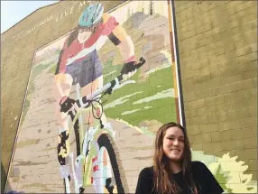  ??  ?? Lea McCroy, 17, poses for a recent photo in front of a Canmore mural in memory of her mom, Isabelle Dube, who was killed in a grizzly bear attack in June 2005, in Canmore.