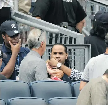  ?? BILL KOSTROUN/THE ASSOCIATED PRESS ?? A young girl is tended to before being carried out of the seating area after being hit by a line drive during a game between the New York Yankees and Minnesota Twins on Wednesday.