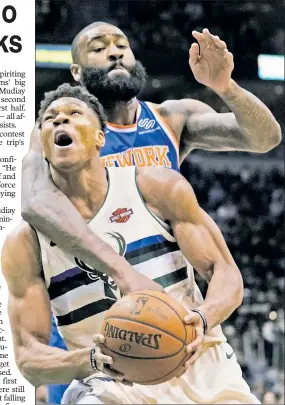  ?? AP ?? GREEK PEAK: Bucks star Giannis Antetokoun­mpo, being fouled by Kyle O’Quinn, dominated with 28 points and 10 rebounds to help hand the Knicks a 120-112 loss at Bradley Center on Friday.