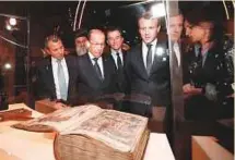  ?? AFP ?? Michel Aoun and Emmanuel Macron at the inaugurati­on of the exhibition at the Arab World Institute in Paris on Monday.