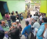  ?? VIRENDRA SINGH GOSAIN/HT PHOTO ?? Police and villagers gather outside the house of the man who was shot dead in Greater Noida on Friday.