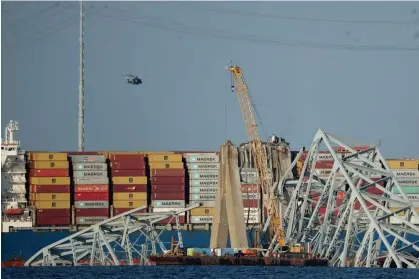  ?? ?? A crane works on the debris of the Francis Scott Key Bridge in Baltimore, Maryland, on Friday. Photograph: Kevin Dietsch/Getty Images