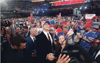  ?? ASSOCIATED PRESS FILE PHOTO ?? In this April 26 photo, Wyoming’s Josh Allen, centre, takes a selfie with Buffalo Bills fans after being selected by the team during the first round of the National Football League draft in Arlington, Texas.