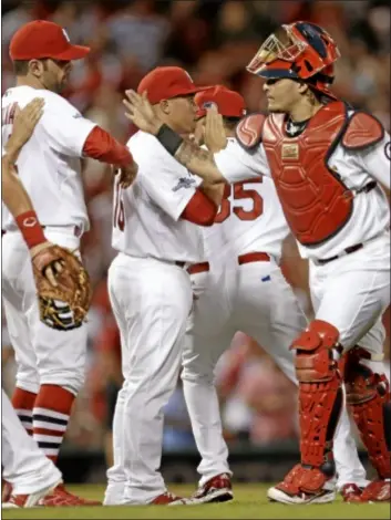  ?? AP Photo ?? The St. Louis Cardinals celebrate after beating the Pirates 9-1.
