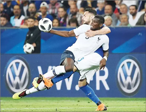  ?? (AFP) ?? France’s midfielder Paul Pogba (left), vies for the ball with Italy’s defender Danilo D’Ambrosio during the friendly football match between France and Italy at the Allianz Riviera Stadium in Nice,
southeaste­rn France, on June 1.