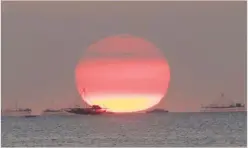  ??  ?? Houses on stilts are seen as the Sun sets around the Manila bay in Philippine­s, February 5, 2015. REUTERS