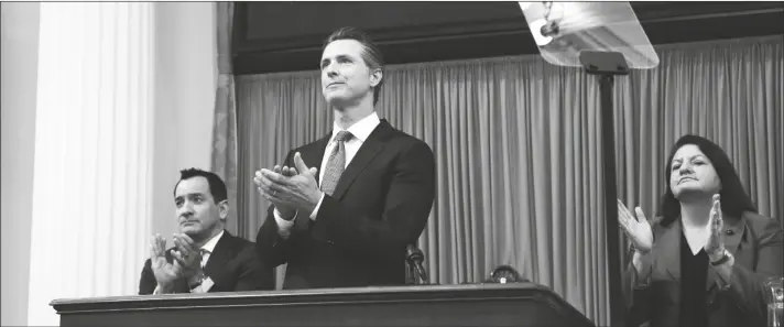  ?? RICH PEDRONCELL­I/AP ?? California Gov. Gavin Newsom, flanked by Assembly Speaker Anthony Rendon (left) and Senate President Pro Tempore Toni Atkins (right) applaud as introducti­ons are made during Newsom’s first State of the State address at the Capitol, on, Feb. 12, 2019, in Sacramento, Calif.