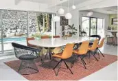  ?? ?? DESIGNERS Kevin Kemper, below left, and Howard Hawkes renovated their Palm Springs home with a Modern Midcentury aesthetic, mixing period pieces with new items such as the custom dining table.