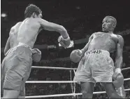  ?? ERIC DRAPER, FILE/AP PHOTO ?? In this April 12, 1997, file photo, Pernell Whitaker, right, leans away from a punch by Oscar De La Hoya during their WBC Welterweig­ht Championsh­ip fight at Thomas & Mack Center in Las Vegas.