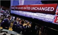  ?? RICHARD DREW — THE ASSOCIATED PRESS ?? The rate decision of the Federal Reserve appears on a television screen, on the floor of the New York Stack Exchange, Wednesday. The Federal Reserve says it will start in October to gradually unwind its $4.5 trillion balance sheet, which expanded to...