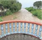  ?? CRUZ/PACIFIC DAILY NEWS VIA AP RICK ?? The Laelae River in Umatac, Guam, becomes swollen Tuesday with the addition of rain runoff resulting from increased shower activity as Typhoon Mawar approaches the region.