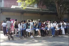  ?? THE ASSOCIATED PRESS ?? People wait in line to enter the Thai Embassy in Yangon, Myanmar, Tuesday for visa appointmen­ts.