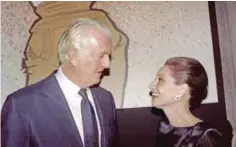  ?? —AFP ?? This file photo taken on October 21, 1991 shows French designer Hubert de Givenchy (left) and American actress Audrey Hepburn talking with each other at the Galliera Museum in Paris during a reception honoring Givenchy for his 40 years in fashion.