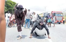  ?? ?? Omar Harriott (left), aka ‘Lastic Man’, and Wayne Clarke, aka ‘Cranky Jawbone’, bringing fun and enjoyment.