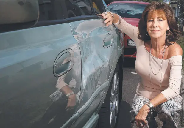  ??  ?? BATTERED: Cairns woman Vicki Godfrey is furious after she was attacked in the street by a man who ran into her car in the CBD. Picture: JUSTIN BRIERTY