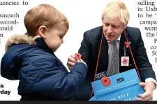  ??  ?? PRIDE: Mr Johnson was selling poppies yesterday