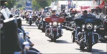  ?? (File Photo/Rapid City Journal/Josh Morgan) ?? Bikers ride down Main Street in downtown Sturgis, S.D., before the 2016 motorcycle rally officially begins.