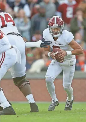  ?? GARY COSBY JR./USA TODAY SPORTS ?? Alabama quarterbac­k Bryce Young (9) evades the Auburn pass rush at Jordanhare Stadium in Auburn, Ala., on Nov. 27.