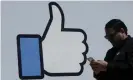  ??  ?? A man walks past Facebook headquarte­rs in Menlo Park, California. Photograph: Jeff Chiu/AP