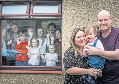  ??  ?? Emma and Roy Hann with their children in March, left, and striking the same pose in Dundee yesterday, below.