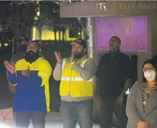  ?? NELVIN C. CEPEDA U-T ?? At a Jan. 11 meeting of the Chula Vista City Council, Republic Services drivers Cesar Silva, left, and Dohney Castillo applaud a question posed to Republic officials by a council member.