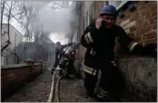  ?? EVGENIY MALOLETKA — THE ASSOCIATED PRESS ?? A rescue worker speaks on the phone while his team battles a fire in a house that was shelled by Russian forces in Kostiantyn­ivka, Ukraine, on Friday.