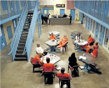  ?? JULIE JACOBSON/THE ASSOCIATED PRESS ?? Inmates inside Albany County jail’s veteran’s pod gather for a group session with Sarah Polidore, centre, executive director of field services for Moral Reconation Therapy, on Nov. 27, 2017, in Albany, N.Y. Albany County’s jail devotes one of its...