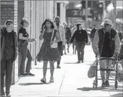  ?? Irfan Khan Los Angeles Times ?? L.A. COUNTY has about 340,000 fewer people than in 2019. Above, pedestrian­s on 7th Street downtown.